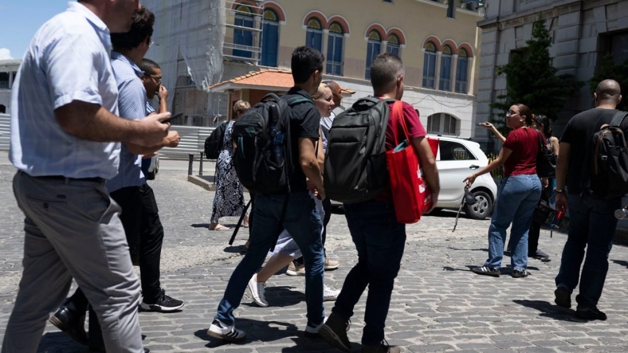 Trabalhadores são vistos em uma rua após evacuarem seus escritórios devido a um