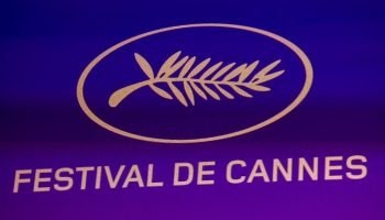 Imagem colorida de Logo do Festival de Cannes exibida durante a coletiva — Foto:
