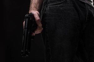 killer-with-gun-black-background-studio-1-