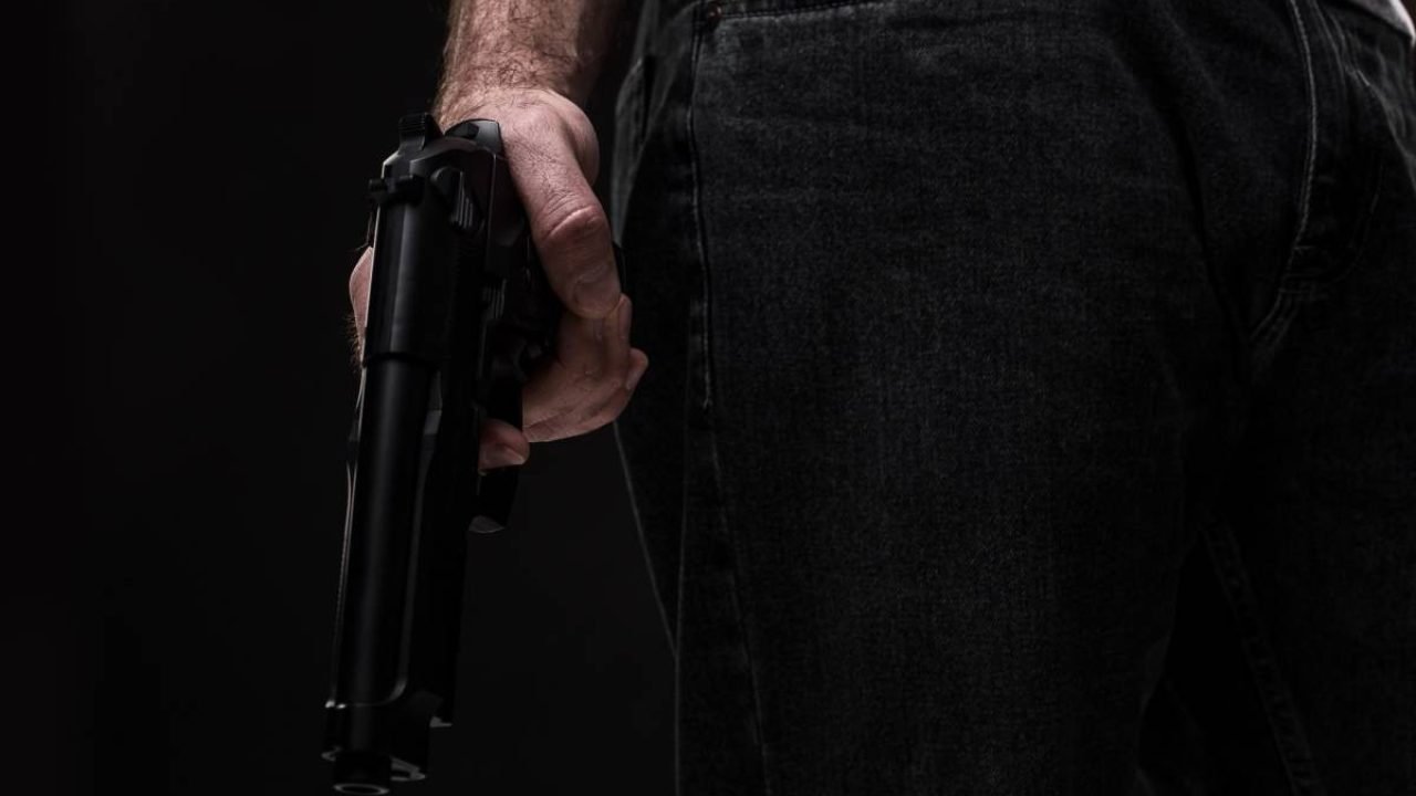 killer-with-gun-black-background-studio-1-
